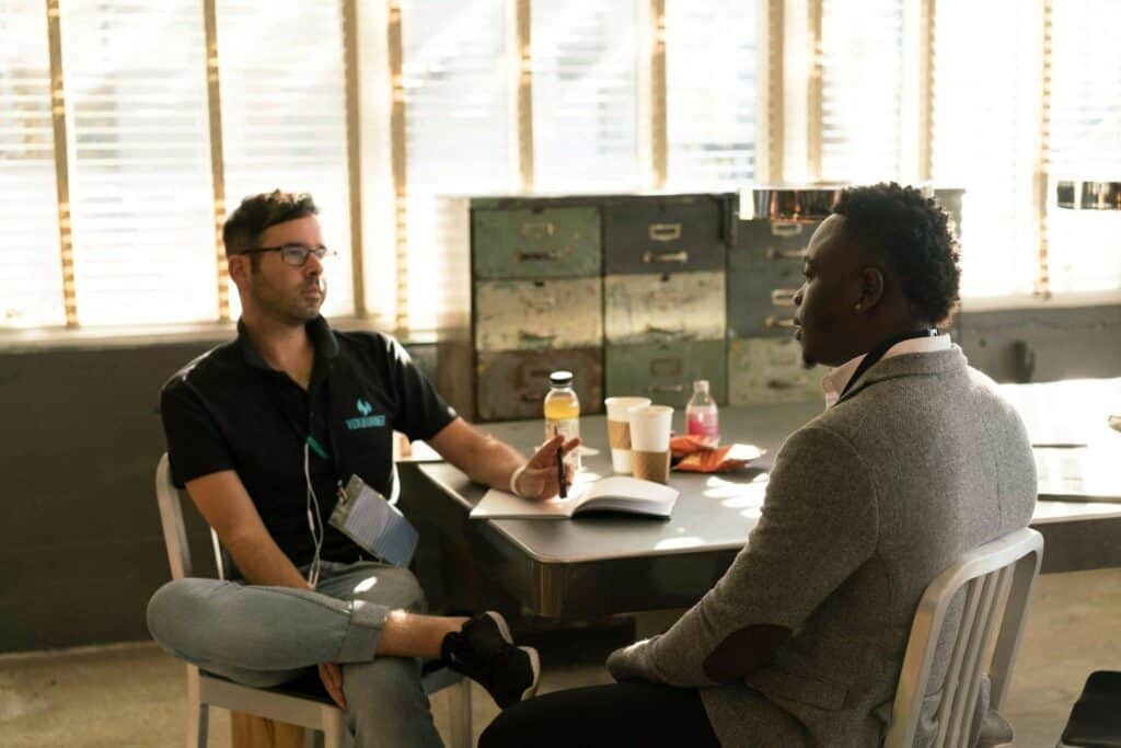 Two people sitting at a table consulting about CBT